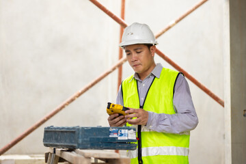 Use construction tools and open tool box. Balance Bubble level ruler, Tools equipment building and engineering. Civil engineer Asian man in safety hard hat helmet working at construction site