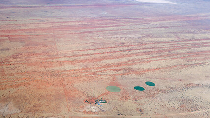 round fields cultivation and lines of Kalahari parallel red dunes, near Auob Camp, Namibia
