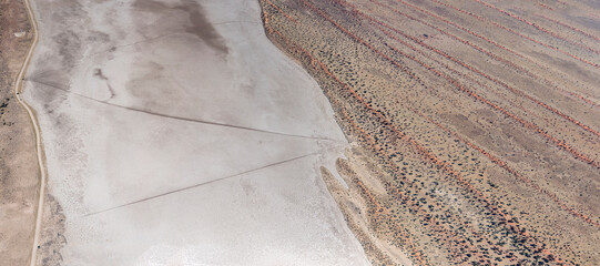 tracks on large pan among red dunes in Kalahari desert, near Auob Camp, Namibia