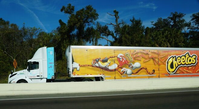 Florida, U.S.A - Jan 2, 2026 - A Cheetos-branded trailer features Chester Cheetah in vibrant snack-themed mobile advertisement.