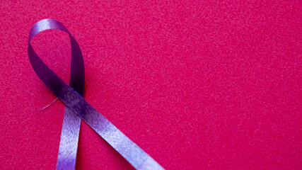 Purple ribbon on a pink background. Symbolizes World Cancer Day, observed on February 4th. The...