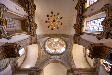 Ornate interior ceiling with illuminated chandelier and church dome © Richard Semik
