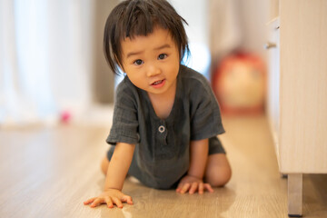Curious Toddler Touching Air Purifier Indoors.