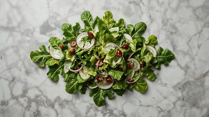 Fresh mixed greens with radicchio, spinach, and cranberries on a marble surface. Healthy salad ingredients.