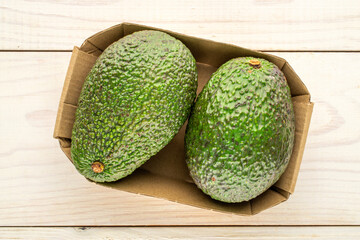 Ripe avocados on a wooden table, close-up, top view.