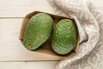 Ripe avocados on a wooden table, close-up, top view.