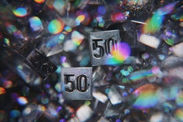 50 percent discount cubes with metallic numbers floating among sparkling glass fragments in dark abstract environment with rainbow light reflections concept of ecommerce retail marketing