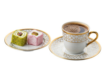 gold patterned tea cup with saucer and colorful swiss rolls on white plate