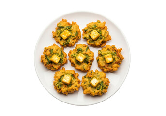 paneer pakora fritters with herbs on white plate