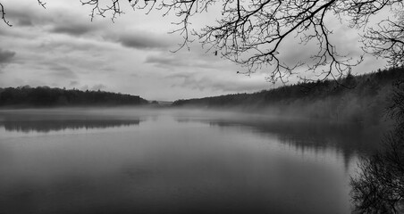 Winter mist settles upon Swinsty Reservoir near Harrogate, North Yorkshire, United Kingdom - black and white version