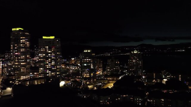 City highrise buildings at night aerial fly over
