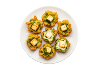 crispy paneer fritters with greens on white plate