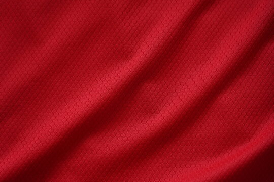 Close up of red football jersey sports clothing fabric texture.