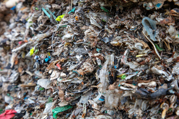 shredded and pressed recyclable plastic waste that has been burned and causes environmental pollution.