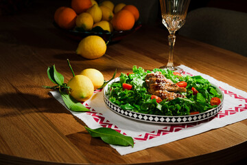 mediterranean styled salad with green lettuce leaves, peas, grilled chicken meat, cherry tomatoes, dressed with olive oil, served for one