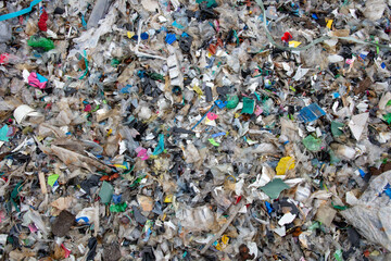 shredded and pressed recyclable plastic waste that has been burned and causes environmental pollution.