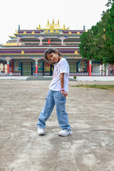 Child plays in front of cultural temple during daytime