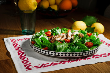 grilled chicken salad with green lettuce, grilled meat, green peas, tomatoes, lemons, fresh natural healthy mediterranean styled meal