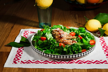 grilled chicken salad with green lettuce, grilled meat, green peas, tomatoes, lemons, fresh natural healthy mediterranean styled meal