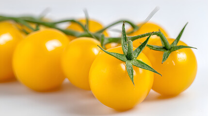 Fresh yellow cherry tomatoes on vine in closeup
