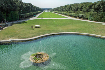 Elegant Italian park with central fountain, clear water, extensive green lawn, and tree-lined alleys. Serene landscape, travel destination, and relaxation scene for nature, tourism, and architecture 