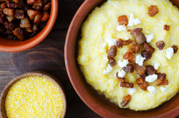 Traditional Banosh with cheese and bacon in rustic ceramic bowl