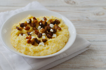 Banosh with brynza cheese and cracklings in minimalistic style