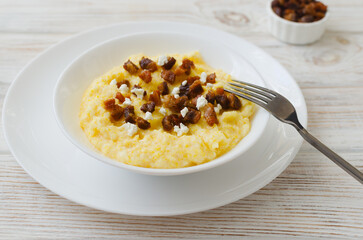 Banosh with brynza cheese and cracklings in minimalistic style