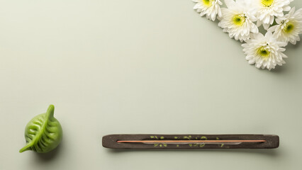 Pastel Qingming festival background featuring calm copyspace background with incense and flowers. Minimal spring design background with open space for text