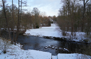 Ilm River and Park in Weimar, Germany covered in snow, winter season