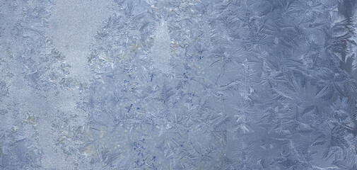 Fototapeta premium Ice crystals in the detail on a window glass in winter time