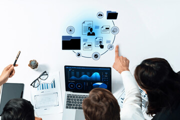 A business team engaged in digital data analysis using a laptop and visual graphics, fostering collaboration and strategic insights in a modern workspace environment. Trope