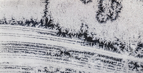 Ice crystals in the detail on a window glass in winter time