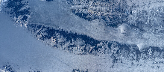 Ice crystals in the detail on a window glass in winter time
