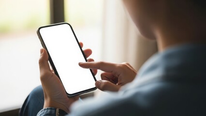 Person using smartphone while sitting near a window