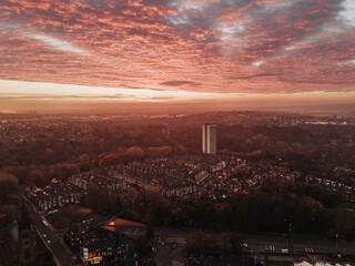 Newcastle upon Tyne UK: 9th Nov 2025: Dawn breaks over Newcastle Jesmond as the sun rises. The sky turns pink and purple while trees and buildings stand out. Autumn colours fill the scene