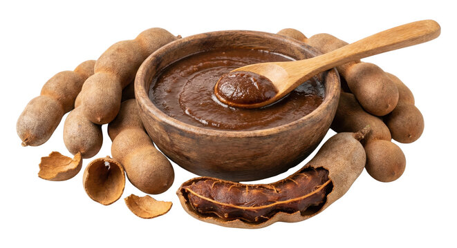 Tamarind paste in wooden bowl with fresh whole pods and peeled tamarinds on transparent background