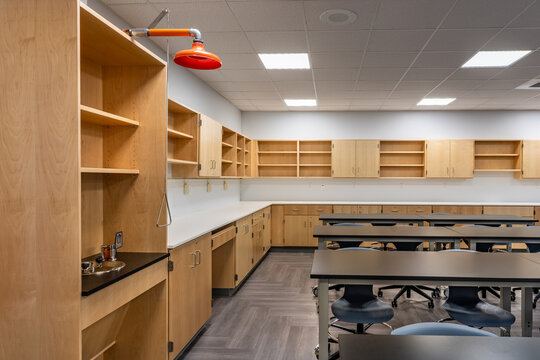 Example of a new empty nondescript US High School science classroom with desks, chairs, and white board. Classroom could be in almost any US High School. Nobody included in image.