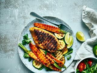 Grilled chicken breast with soft grilled vegetables. Low carb diet. Copy space. Top view