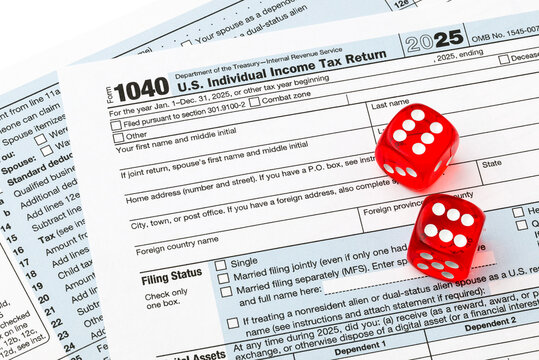 United States - January 2, 2026; IRS individual Income Tax Return Form 1040 with pair of red dice rolled double six for luck