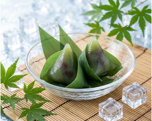 Traditional Japanese Wagashi Wrapped in Bamboo Leaves with Maple Leaves