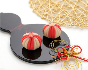 Traditional Japanese Wagashi Sweets in Red and White on Black Plate
