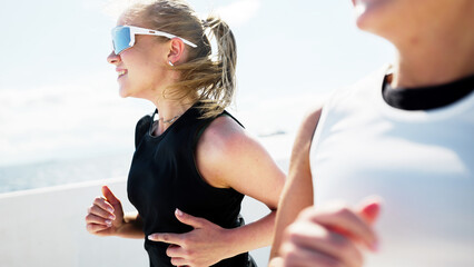 Women running during outdoor workout on sunny day