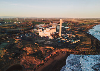 Lynemouth Northumberland: 31st Dec 2025: Lynemouth Power Station stands on a winter morning drone footage. The sun rises, casting light on Industrial buildings and nearby coastline