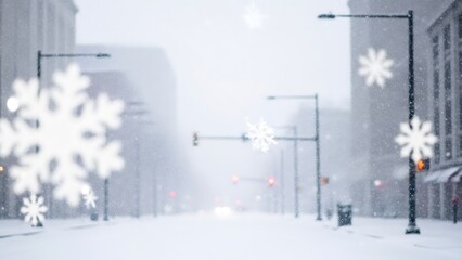 Winter snow falling over empty city street with blurred snowflakes in foreground. Cold weather and seasonal concept for Christmas and New Year.
