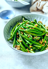 French beans with toasted garlic and pine nuts. Healthy lifestyle concept. Low carb diet. Copy space