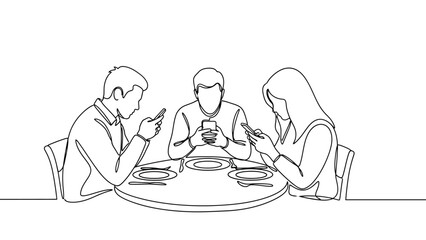 People seated around a table engrossed in their mobile phones