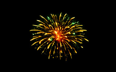 Golden and green fireworks burst in dark night sky creating dazzling display with radiant sparks and trails for festive occasions and celebratory events like holidays and parties