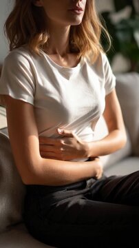 Woman with stomach ache holding her abdomen in pain