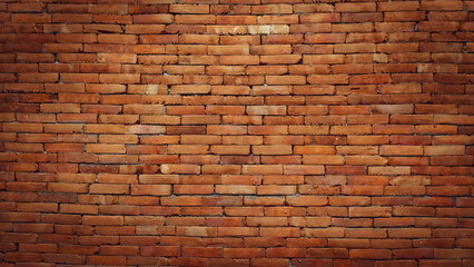 A close-up of a weathered, textured brick wall. The red bricks are stacked tightly together, and show signs of age